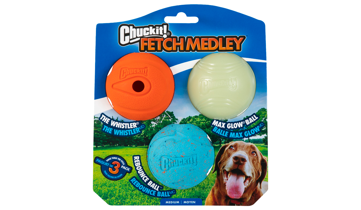 The Chuckit! Medium Fetch Medley Dog Ball Set includes the orange Whistler, glowing white Max Glow Ball, and bouncy blue Rebounce Ball. The packaging features a dog eagerly anticipating play, captured in the bottom right.