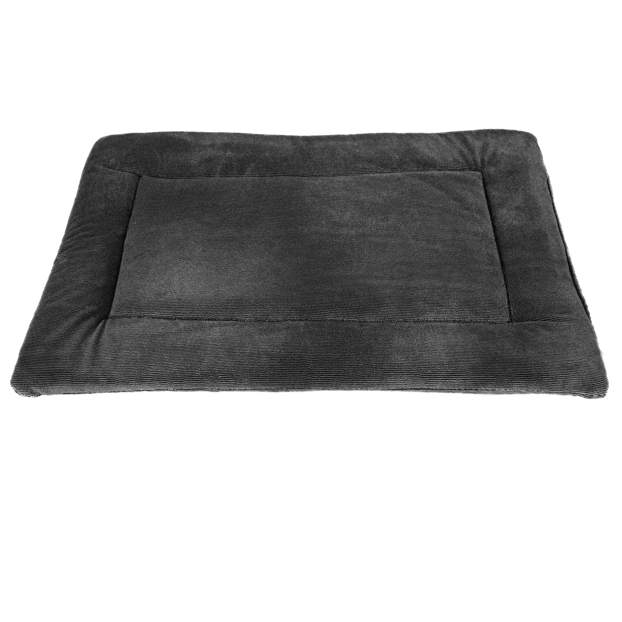 The Pet-mates Kennel Mat by Pet-mates is a plush black rectangular pet bed with slightly raised edges, a soft padded surface, and a non-skid bottom to ensure it stays in place.