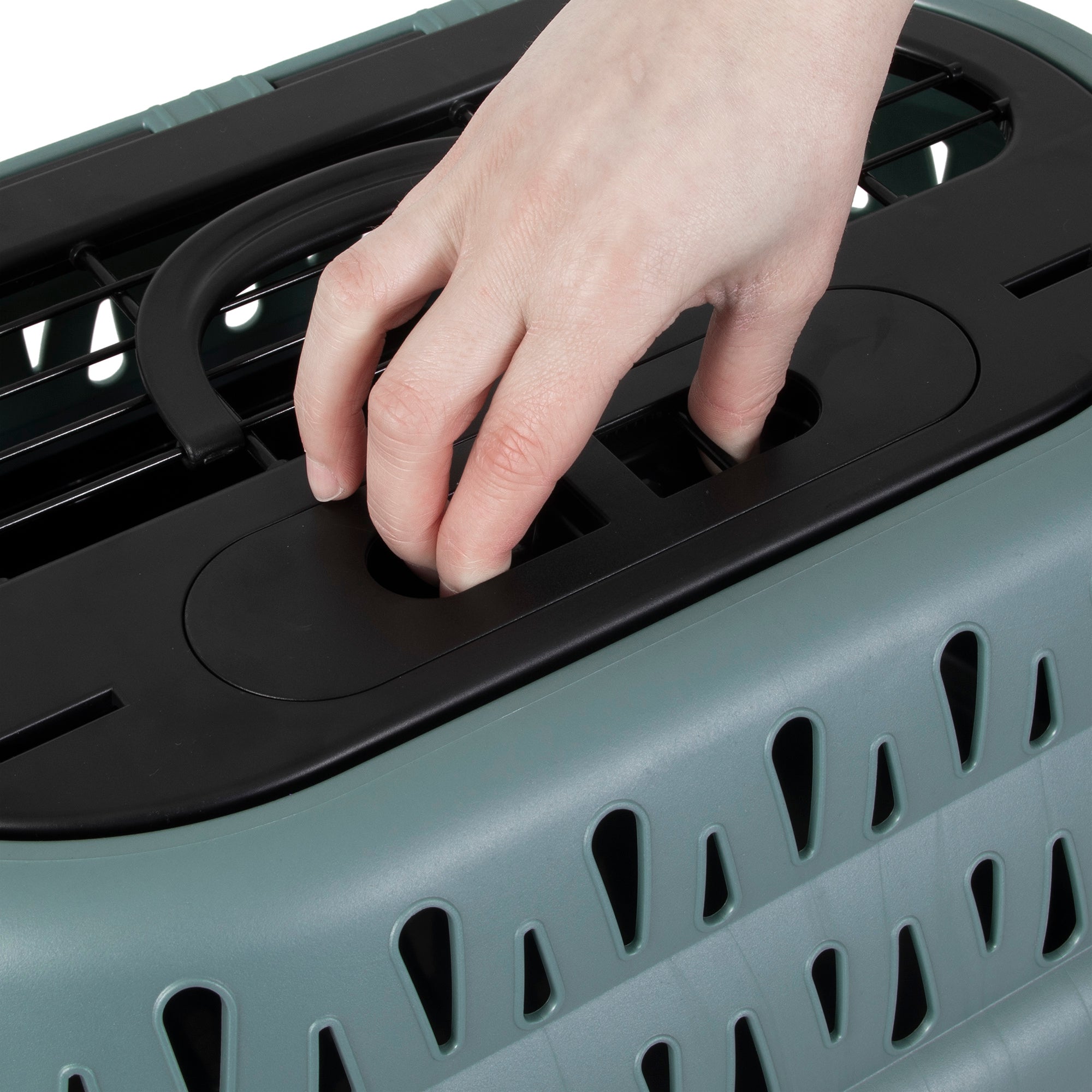 A close-up of a hand operating the black latch on the Pet-mates E-Z Load Top Load Cat Kennel, featuring triangular holes for 360-degree ventilation to ensure your pet’s comfort and stress-free travel.