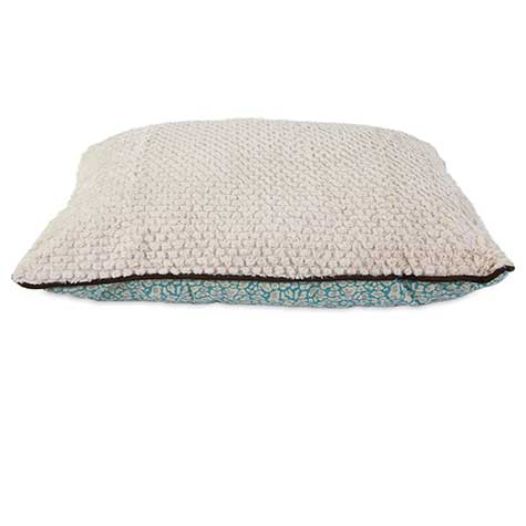 The Pet-mates Two-Sided Fashion Dog Pillow Bed by Pet-mates features a washable, beige textured top and patterned blue bottom with slightly rounded edges, offering a soft and comfortable spot for pets seeking cozy rest.