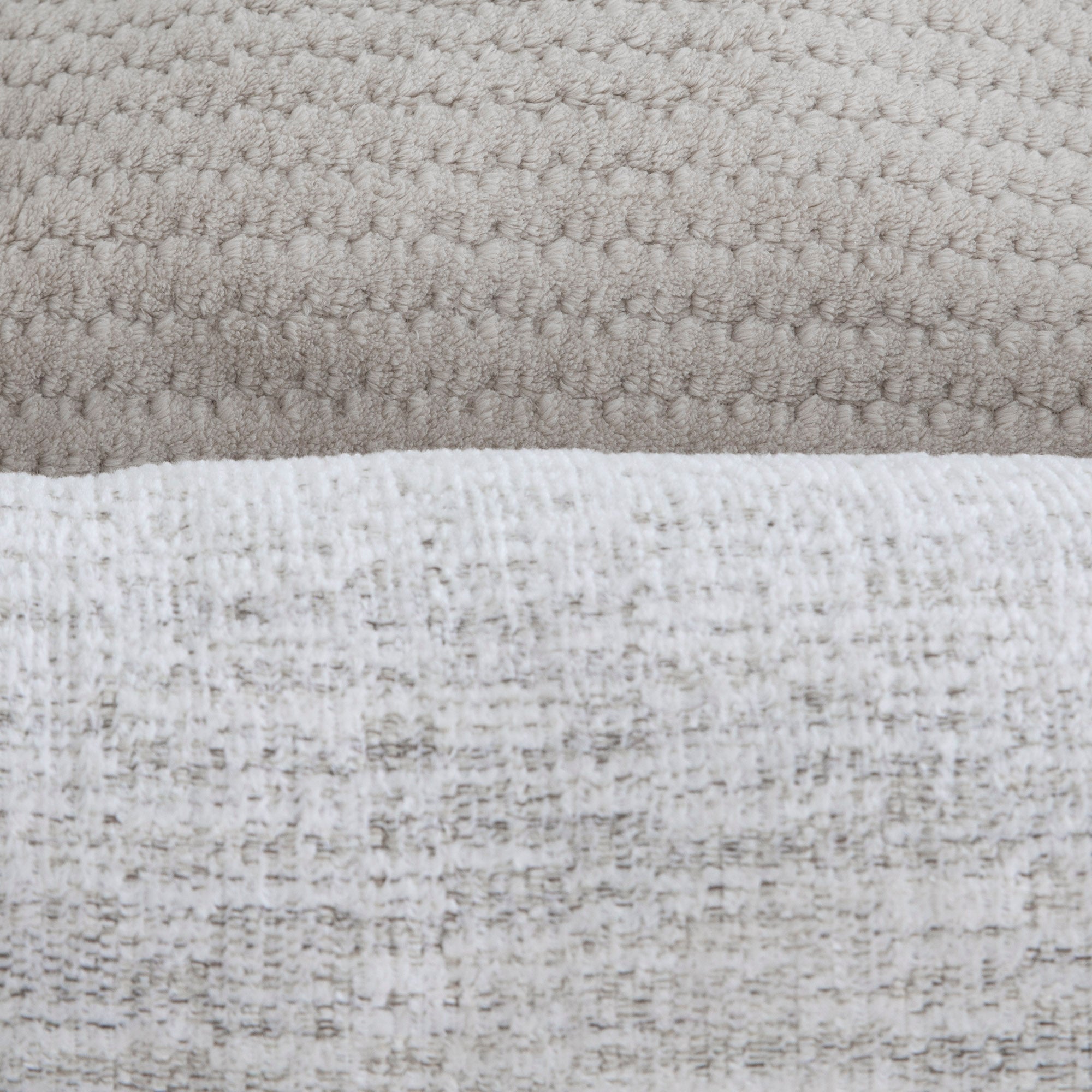 Close-up of two varied fabric textures in the La-Z-Boy Salt & Pepper Rosie Lounger Dog Bed: a light beige, waffle-like top and a lighter grayish white, subtly speckled bottom. This machine washable bed provides style and comfort for your pet.
