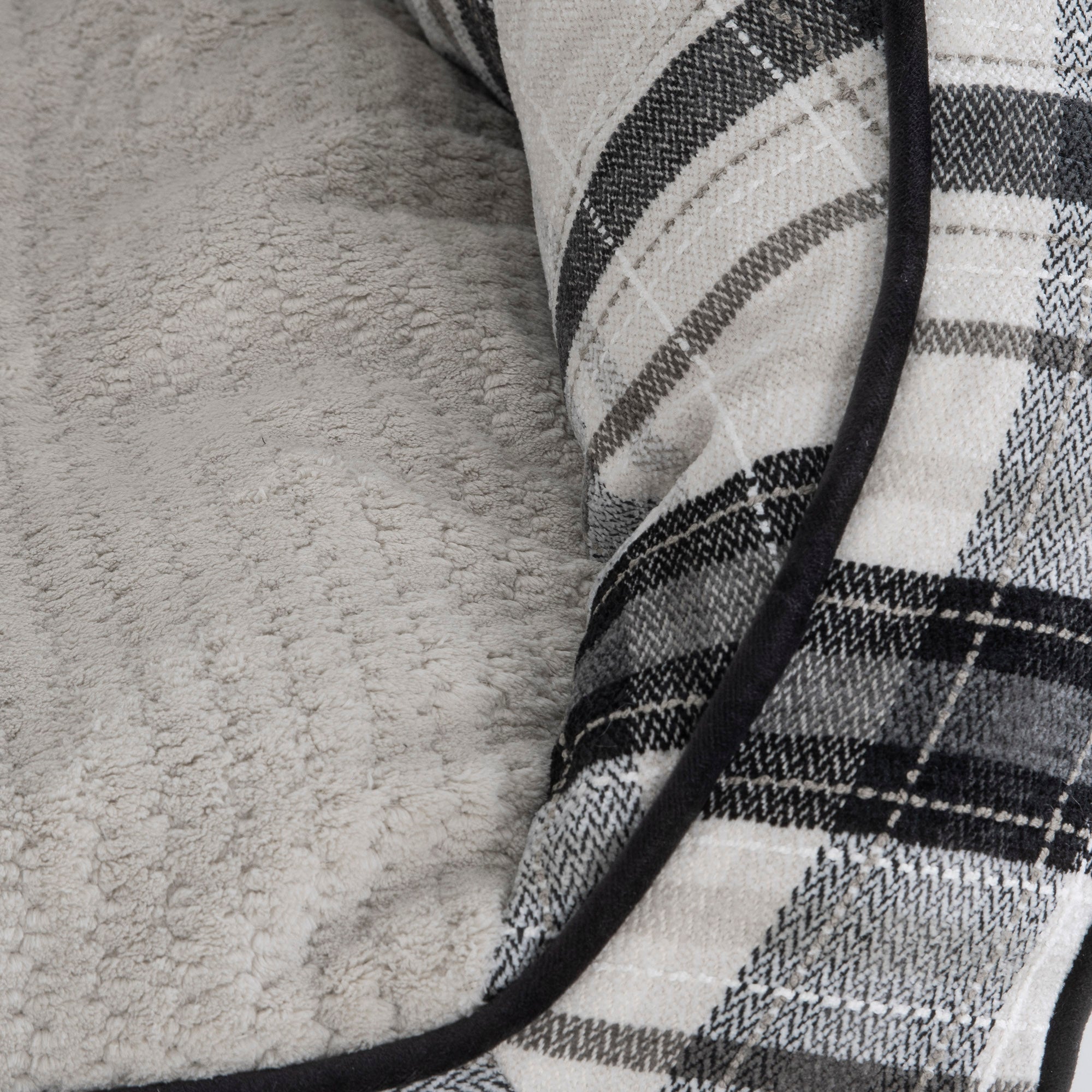 A close-up features a folded plaid fabric in black, white, and gray checks beside a soft light gray textured fabric akin to the cozy La-Z-Boy Harper Sofa Dog Bed. The plaid piece is neatly edged with black trim.
