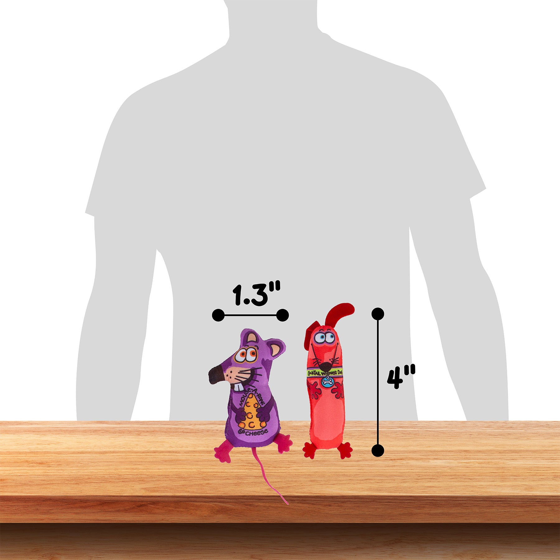 Two colorful FAT CAT Classic Springy Worms cat toys by Fatcat, infused with organic catnip, sit on wood. A person’s silhouette in the background shows scale: a purple toy 1.3 inches wide and red toy 4 inches tall—perfect for intriguing feline minds interested in cat psychology.