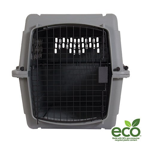 An open, empty Aspen Pet All Purpose - Traditional Kennel by Aspen Pet is shown in grey with a black metal door. A green eco logo appears at the bottom right, and 360-degree ventilation provides comfort during travel.