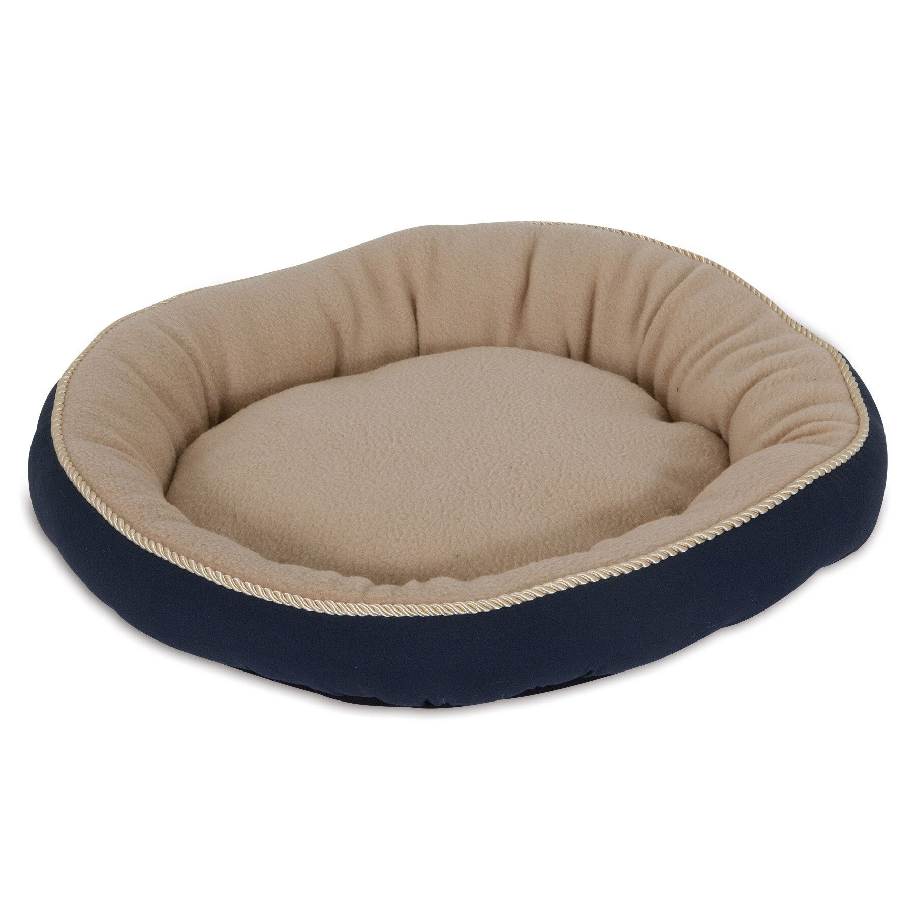 The Aspen Pet Round Pet Bed With Bolster & Gold Cord features a plush beige interior, navy blue edge, and subtle gold rope seam. This cozy and inviting space is machine washable for easy maintenance.
